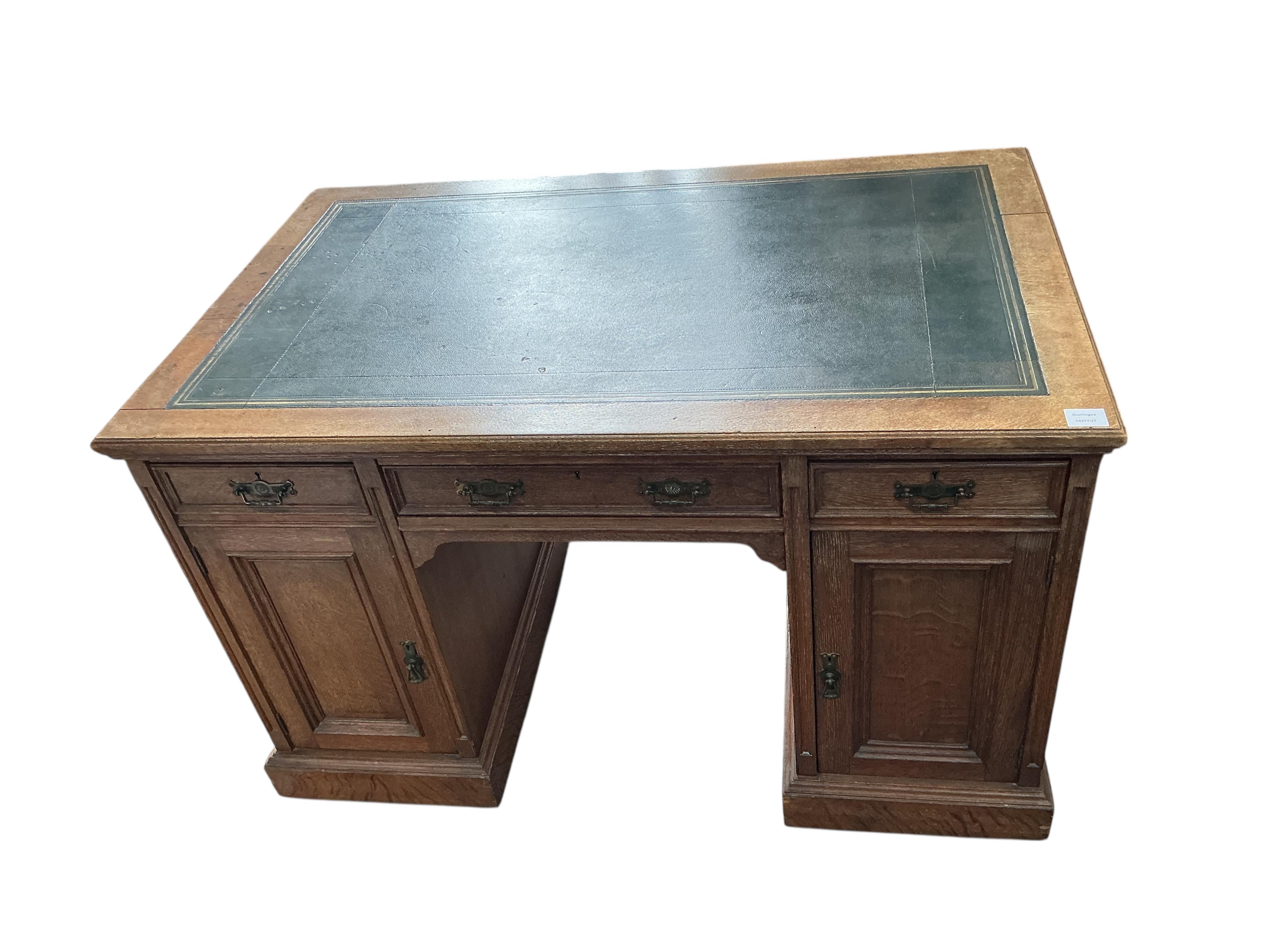 A late Victorian oak kneehole desk, width 122cm, depth 76cm, height 76cm